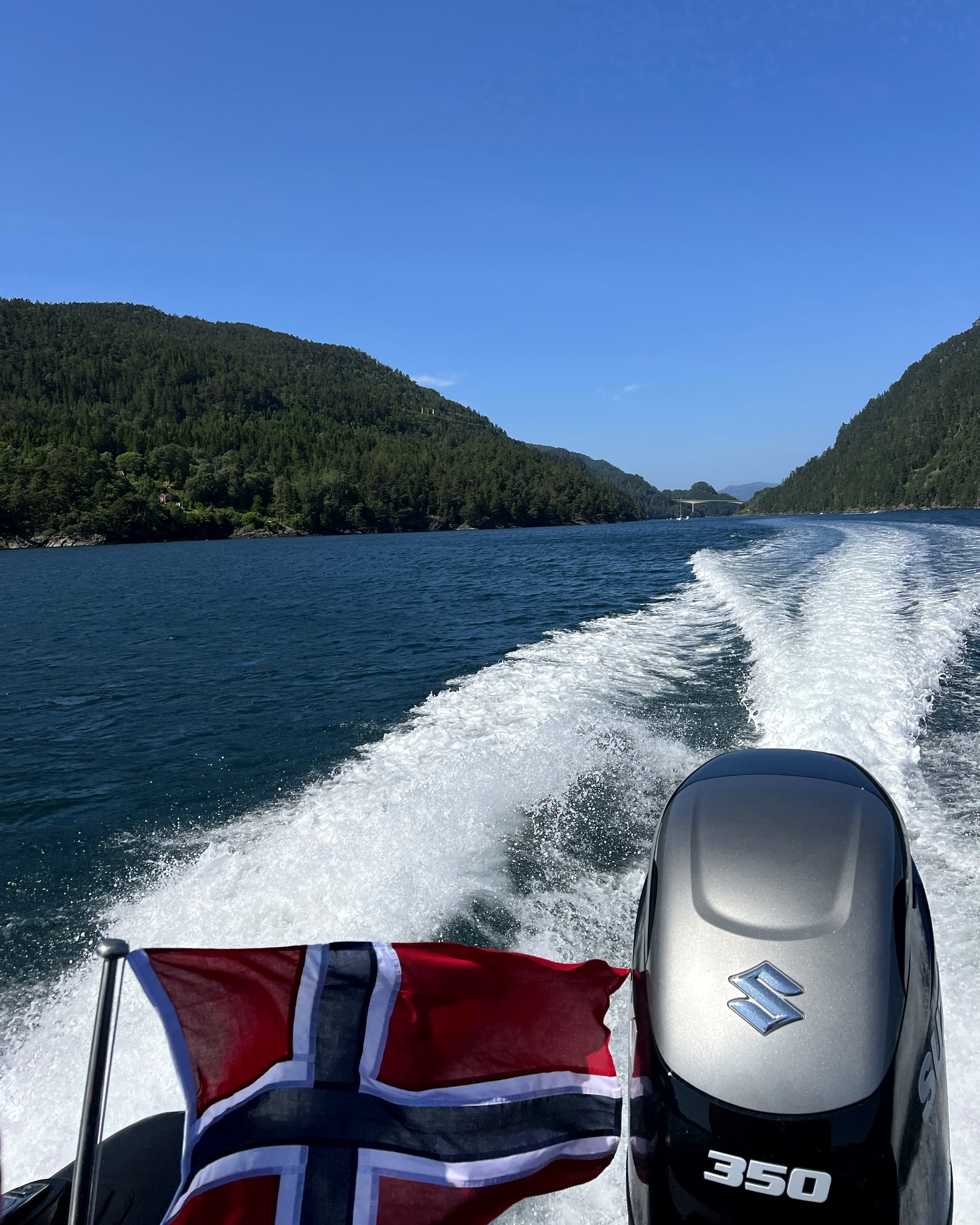 Norwegian flag and outboard engine at speed