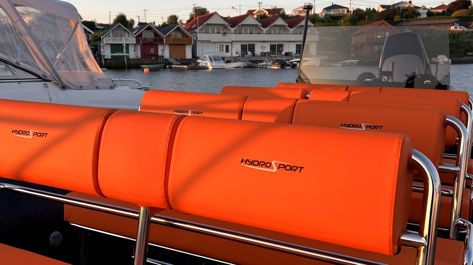 The RIB alongside painted boathouses on Nordåsvannet