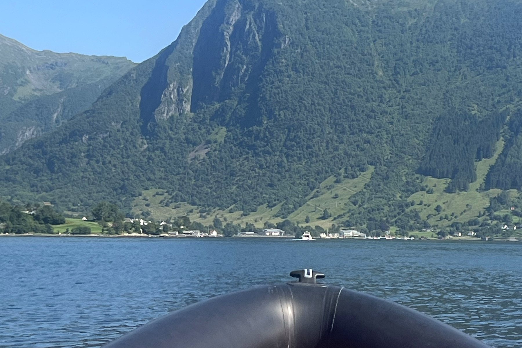 Steep fjord side seen from the bow of the RIB on the way to Mostraumen